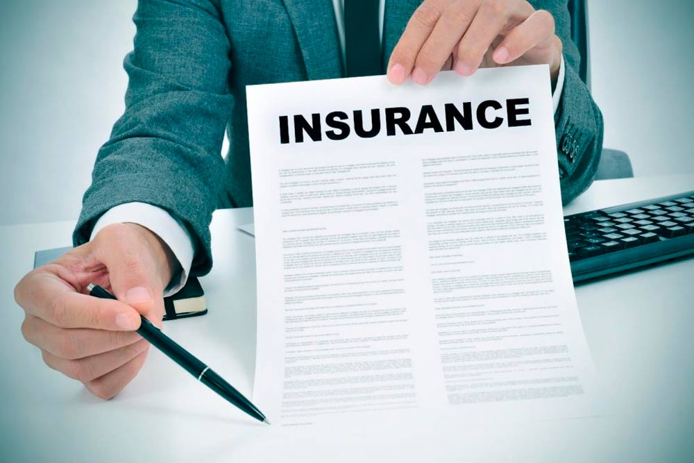 executive handing over a pen to sign an insurance contract