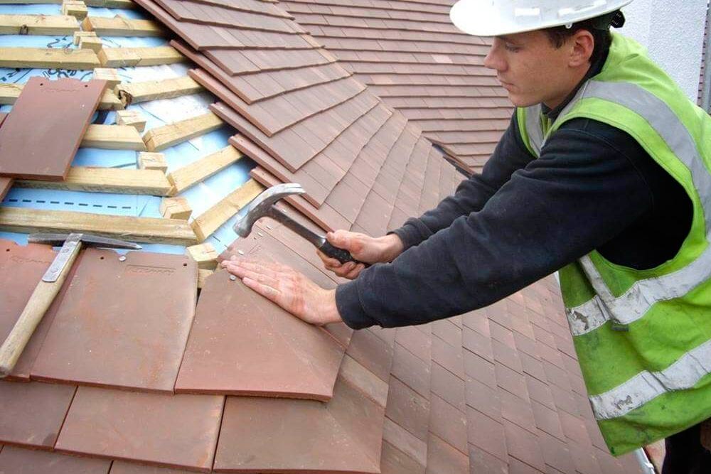 roofer installing shingles