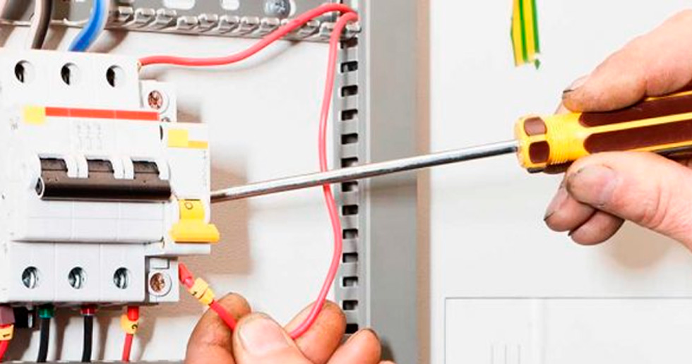 man fixing an electrical switch