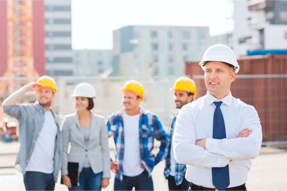 Group of workers with their boss who know Smart Tips to Save On Your Contractor Business Insurance