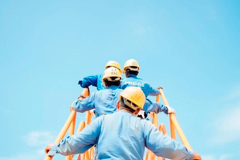 workers climbing up a ladder