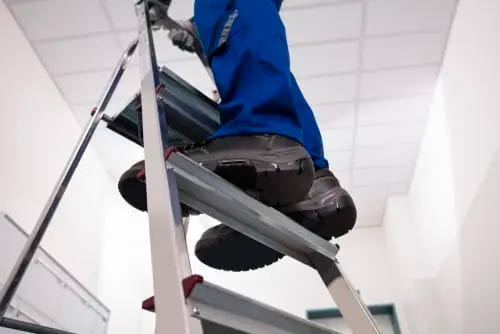 Worker on a ladder who know about the trouble spots that a Handyman should avoid