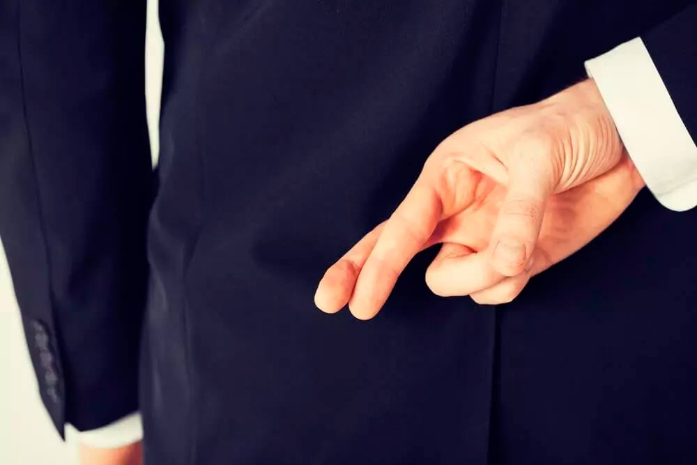 Man crossing his fingers behind his back who know how to Could You Spot a Fake Certificate of Insurance