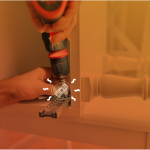 Worker adjusting a cabinet with confidence because he can count on contractor liability insurance