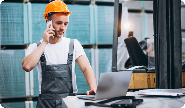three-factory-workers-safety-hats-discussing-manufacture-plan